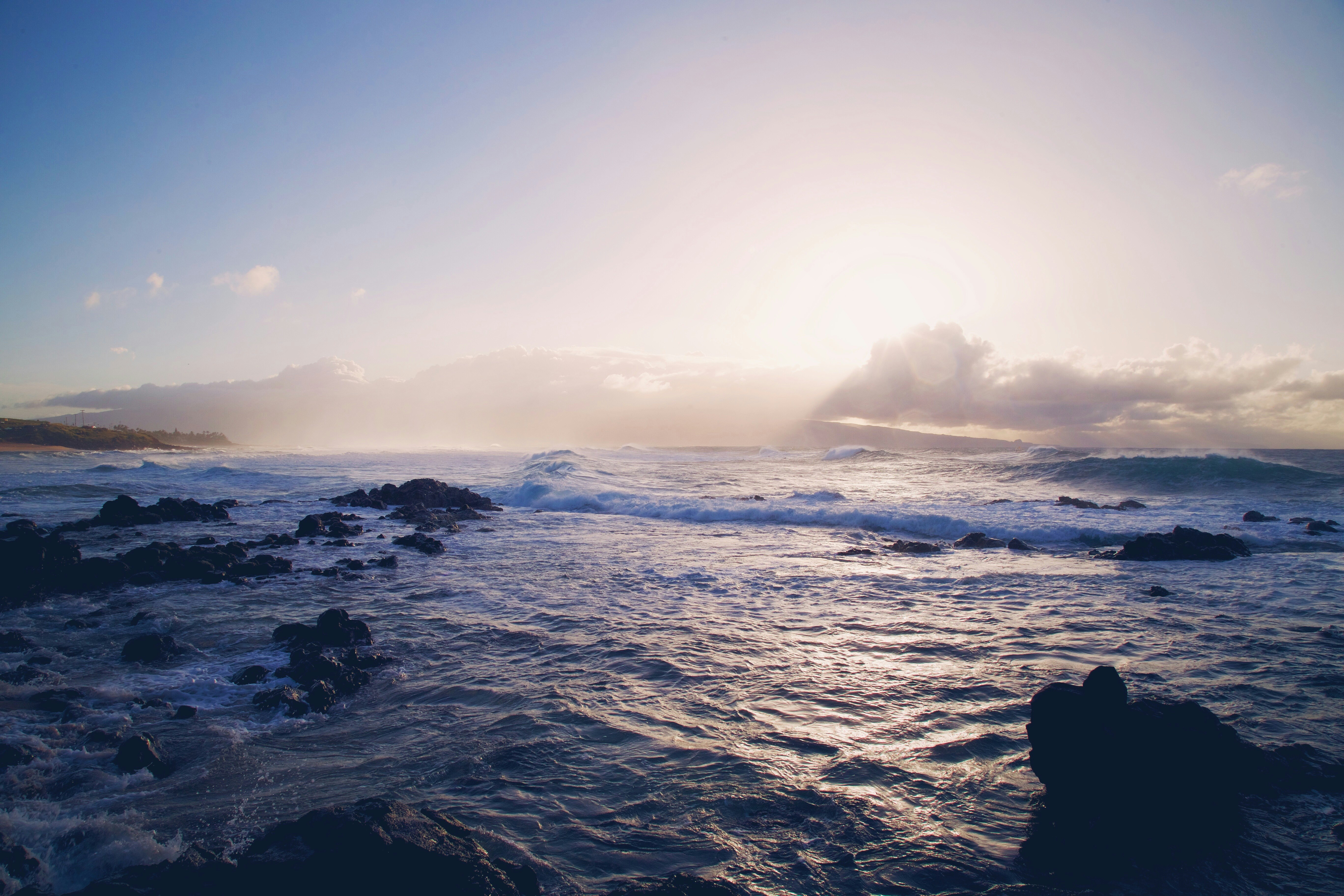 landscape photo of ocean waves crashing rocks